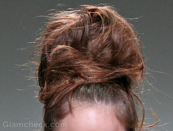 voluminous messy top bun hairdo